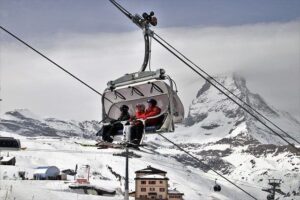 skiers on lift in switzerland