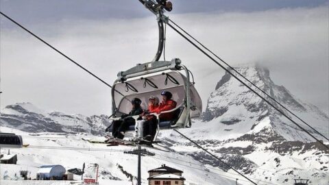 skiers on lift in switzerland