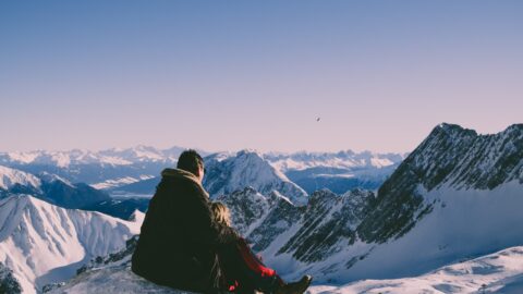 couple sitting in snow verbier