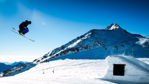 man doing ski jump in snow